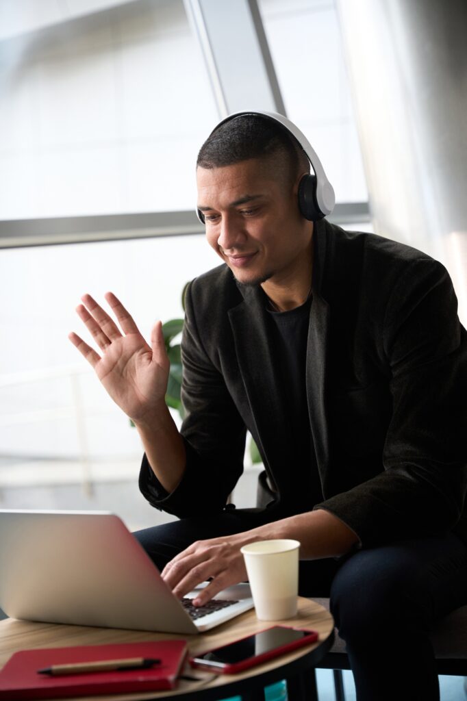 Happy male consultant sitting in front of laptop